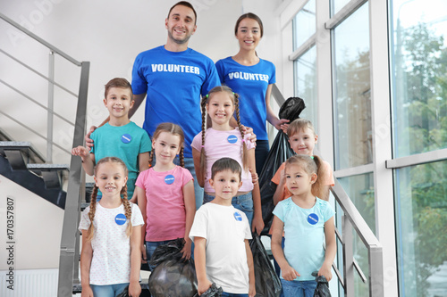 Happy volunteers and childr...