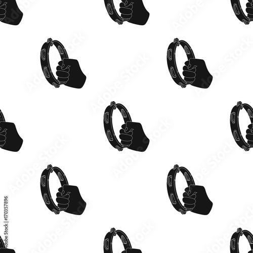 A tambourine that produces a melodic sound. Tambourine in his hand single icon in black style vector symbol stock illustration web.