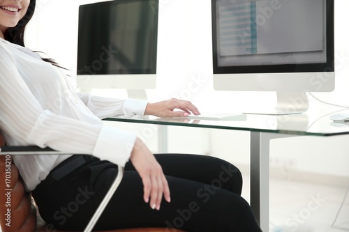 business woman sitting at office desk in modern office © ASDF