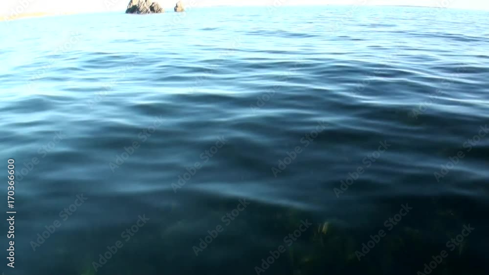 Stone rocks among the watery surface of Arctic Ocean on New Earth. Beautiful landscape of wild nature. Quiet and calm ecotourism in Russia. Panorama of way to cold wilderness. Stone rocks among the watery surface of Arctic Ocean on New Earth. Beautiful landscape of wild nature. Quiet and calm ecotourism in Russia. Panorama of way to cold wilderness.