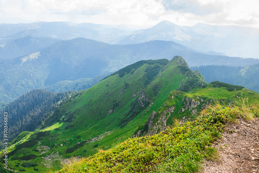 Travel, trekking, nature. Majestic, high green mountains. Horizontal frame