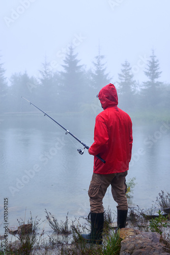Male fishing on foggy weather