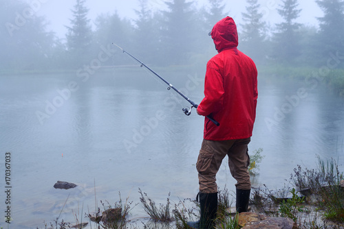 Man with fishing rod on the lake