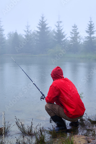 Patient man fishing on the lake