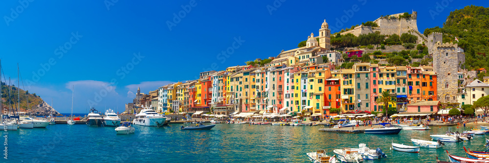 Panorama of colorful picturesque harbour of Porto Venere with San Lorenzo church, Doria Castle and Gothic Church of St. Peter, Italian Riviera, Liguria, Italy.