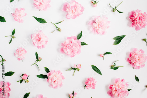 Fototapeta Naklejka Na Ścianę i Meble -  Flower pattern of pink peony flowers, branches, leaves and petals on white background. Flat lay, top view. Peony flower texture.