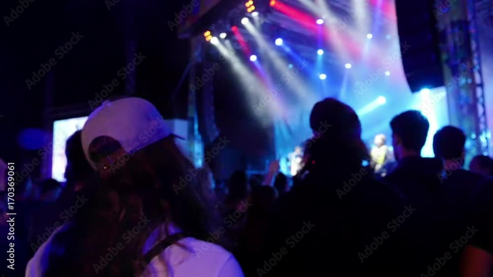 LASKO, SLOVENIA, 2017.07.15: People enjoying music with stage lightning at night. Shot in slow-motion LASKO, SLOVENIA, 2017.07.15: People enjoying music with stage lightning at night. Shot in slow-motion