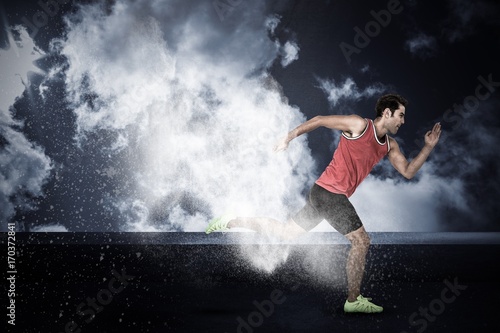 Composite image of confident male athlete running from starting