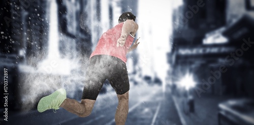 Composite image of male athlete running from starting blocks