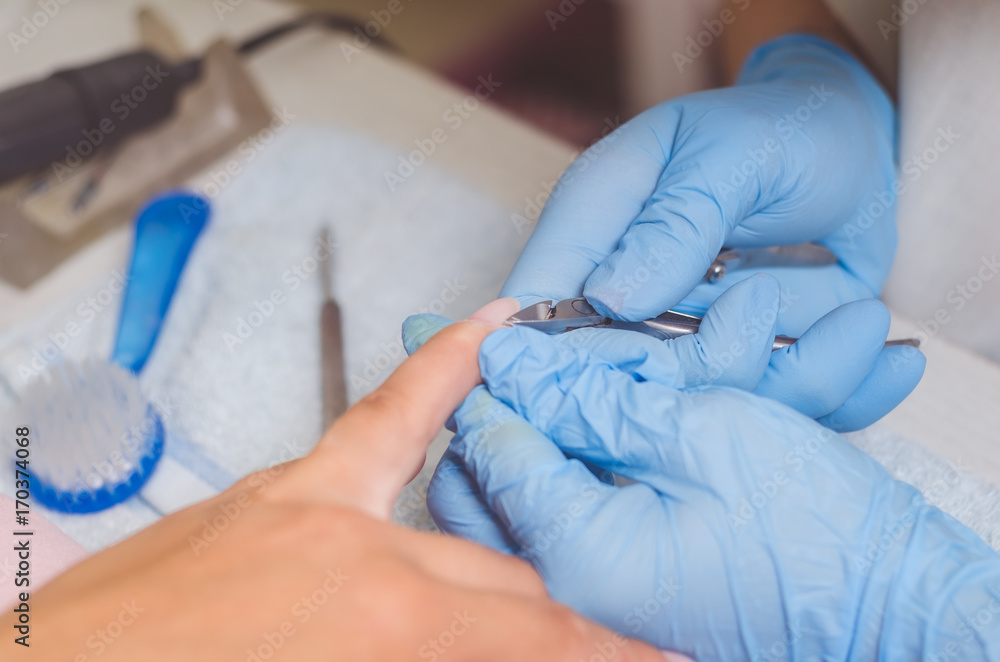 The master prepares the nails for manicure The master prepares the nails for manicure