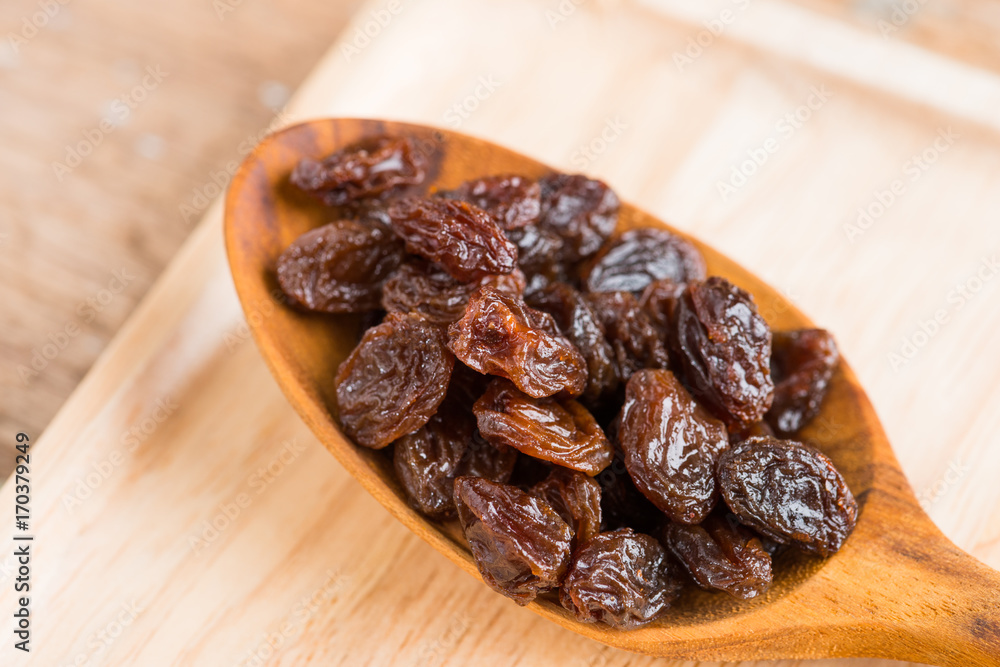 Raisins on a wood background. Raisins on a wood background.