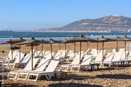Umbrellas and chaise lounges on beach. Agadir. Morocco © Elena Odareeva