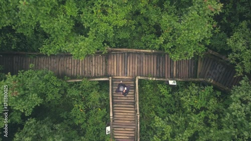 happy woman in rainforest overhead shot