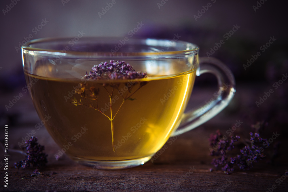 Green tea with herbals. Tea with oregano on the wooden background Green tea with herbals. Tea with oregano on the wooden background