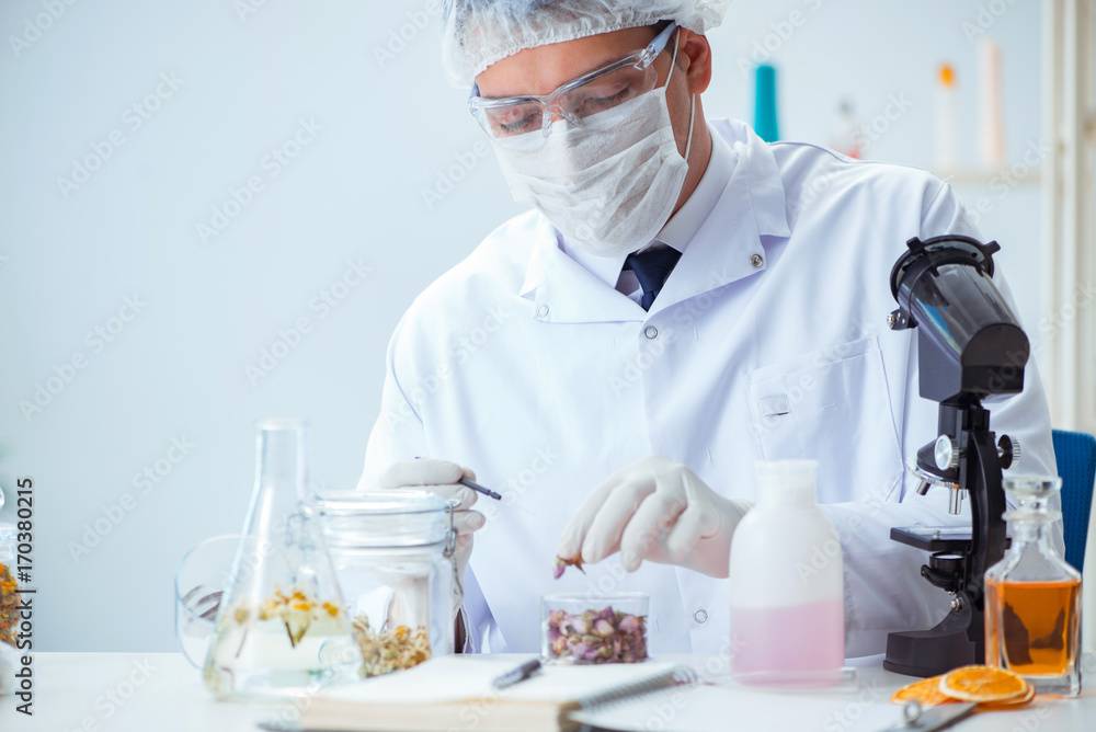 Chemist mixing perfumes in the lab Chemist mixing perfumes in the lab