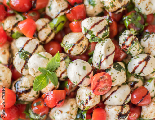 Closeup full frame food - tomato basil mozzarella salad with balsamic glaze