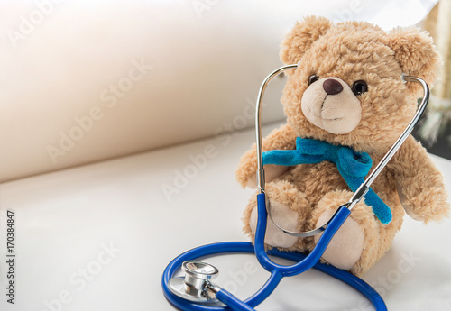 Children doctor concept - Teddy Bear with stethoscope. copy space