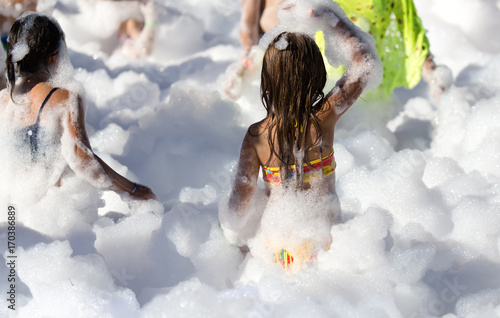 Youth at a foamy party on the beach