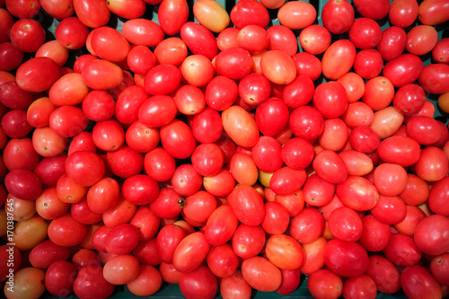 Several tomatoes are sold in the market.