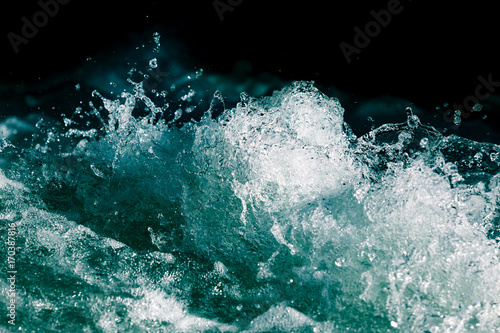 Splash of stormy water in the ocean on a black background