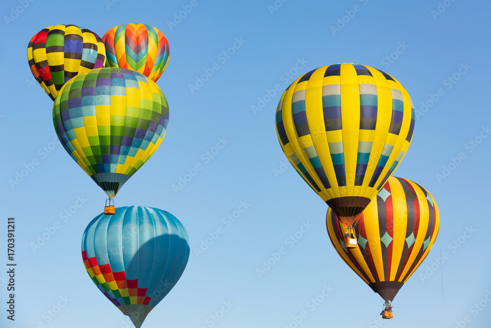 Obraz premium Hot air balloons up in the blue sky