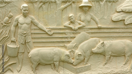 Native Thai culture stone carving on temple wall. © zilvergolf