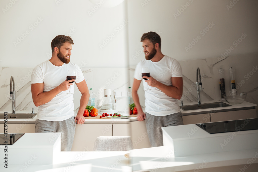 Side view of bearded man on kitchen with ice drink Side view of bearded man on kitchen with ice drink