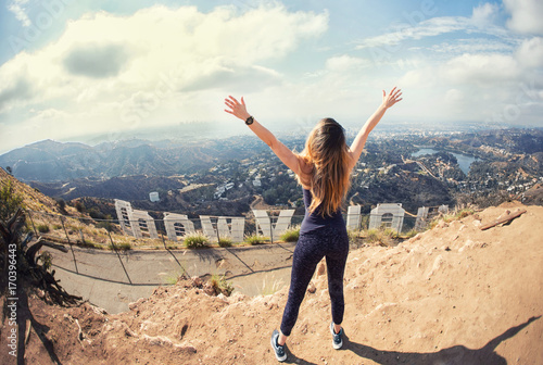 Slika na platnu Young woman at the top of Hollywood, Los Angeles, California