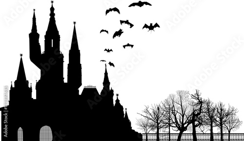 bat silhouettes above large castle isolated on white