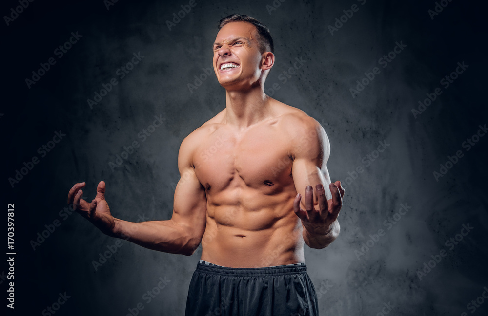 Shirtless sporty male on grey background.