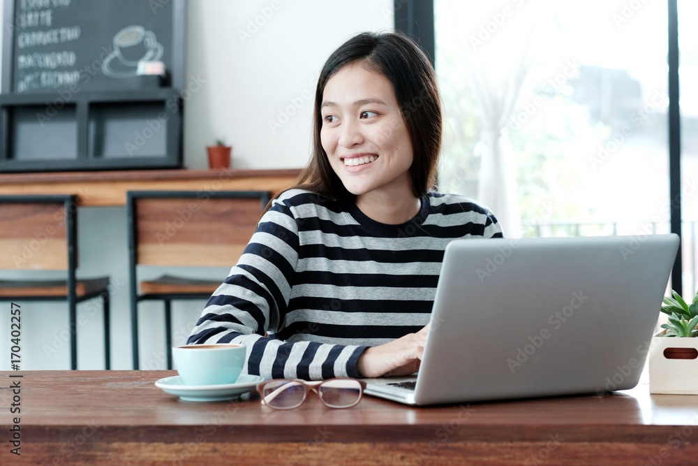 Young asian woman using laptop computer in casual lifestyles, people and technology, lifestyles Young asian woman using laptop computer in casual lifestyles, people and technology, lifestyles
