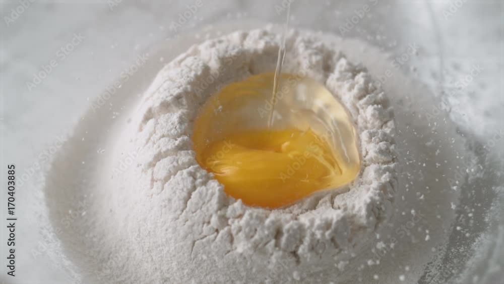 Egg falls on a pile of flour. Shot with high speed camera, phantom flex 4K. Slow Motion. Egg falls on a pile of flour. Shot with high speed camera, phantom flex 4K. Slow Motion.