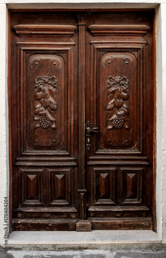 Beautiful old door with ornament of carved wood brown. Beautiful old door with ornament of carved wood brown.