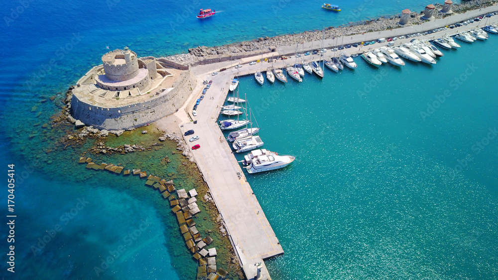 August 2017: Aerial drone photo of iconic medieval fortress of St. Nicholas in port entrance of Rodos island, Aegean, Dodecanese, Greece August 2017: Aerial drone photo of iconic medieval fortress of St. Nicholas in port entrance of Rodos island, Aegean, Dodecanese, Greece