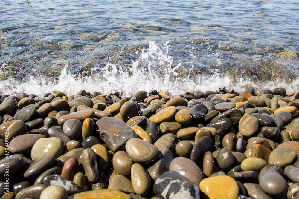Sea and pebbles underwater in a beach. Pebble background