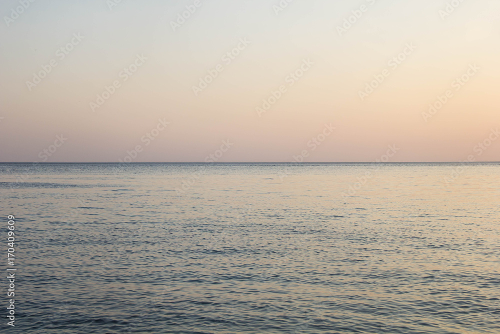 Calm Blue sea waves soft surface Ocean And Blue Sky Background