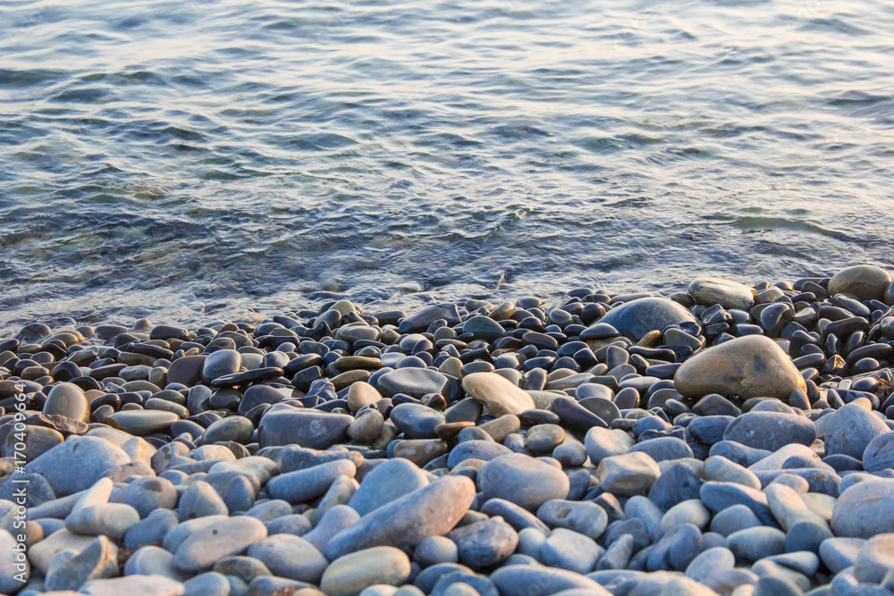 Sea and pebbles underwater in a beach. Pebble background Sea and pebbles underwater in a beach. Pebble background