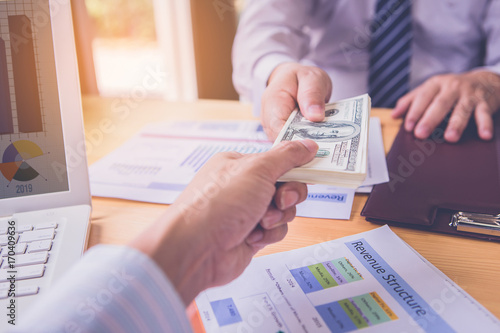 Canvas Print Businessman's hand is giving money for partner