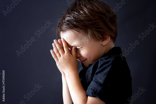 Fotografie Little boy praying, child praying, isolated background