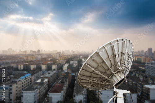 In the city night background large satellite antenna