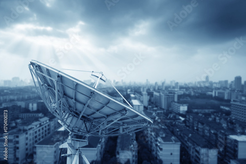 In the city night background large satellite antenna