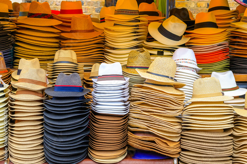 Piles of straw hats on display at Camden Market in London