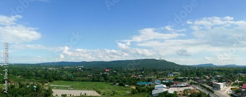 MUKDAHAN, THAILAND - AUGUST 8, 2017: Mukdahan cityscape view that can see big Buddha statue on the mountain.