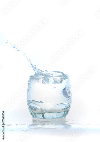 cool water, Ice cubes splashing into glass of water, water splashing from ice cubes being dropped in a glass.