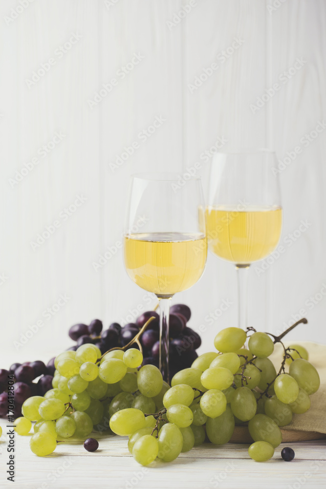 Two glasses of white wine, fresh grapes and pears Two glasses of white wine, fresh grapes and pears