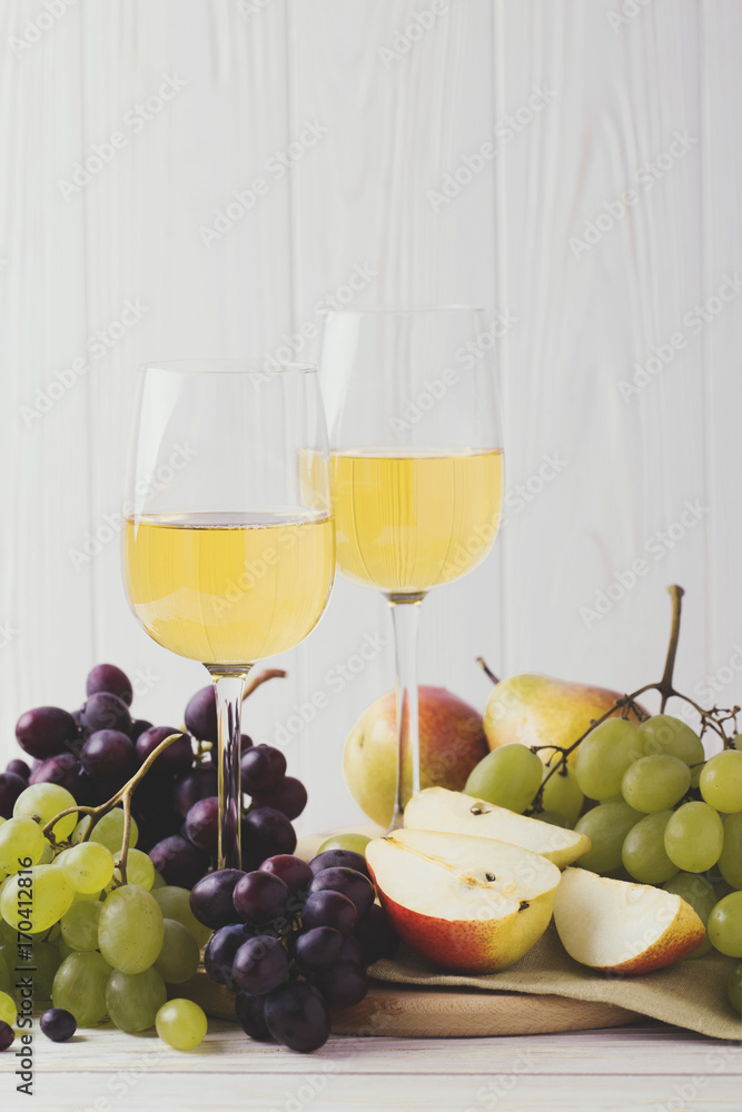 Cheese plate served with wine, fresh grapes and pears