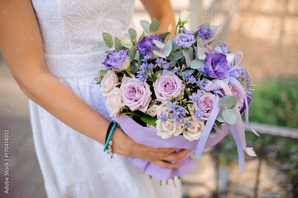 Stylish beautiful bride holds a wedding bouquet in hands Stylish beautiful bride holds a wedding bouquet in hands