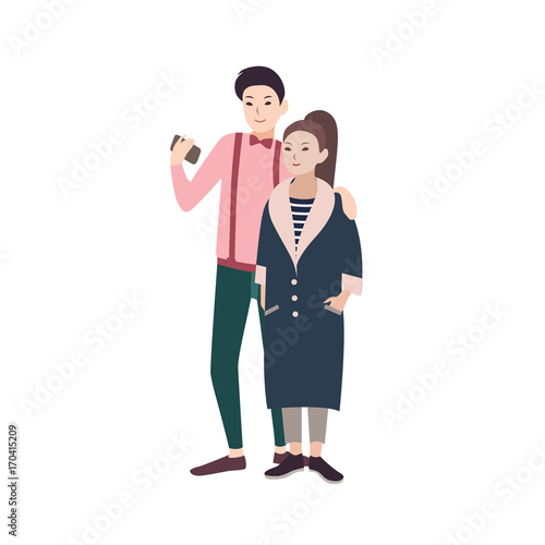 Young fashionable couple of man and woman dressed in stylish clothes embracin...