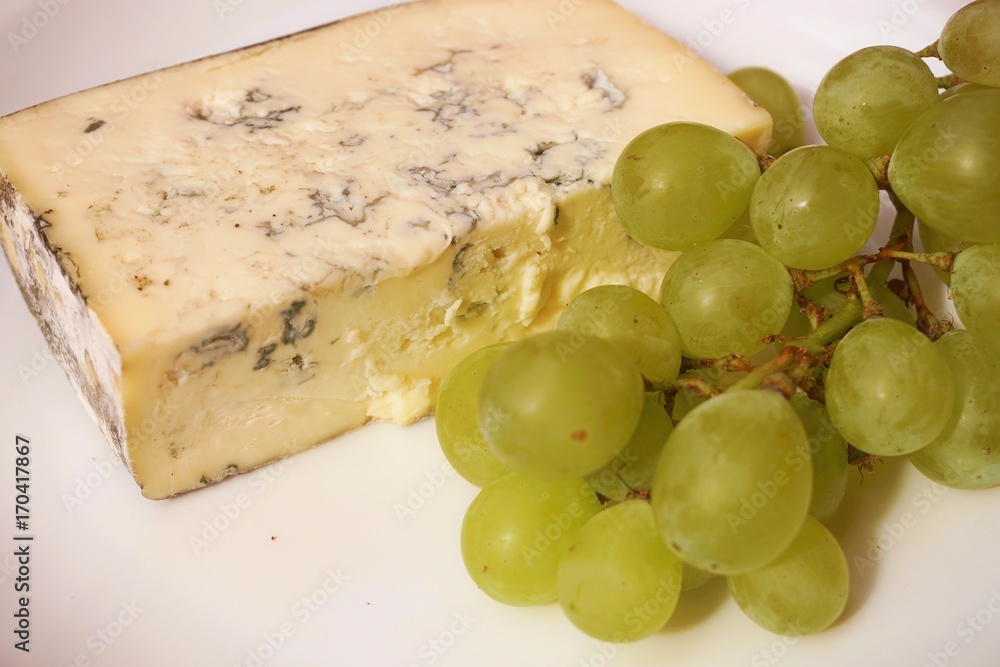 Red grapes with cheese on white background. Red grapes with cheese on white background.
