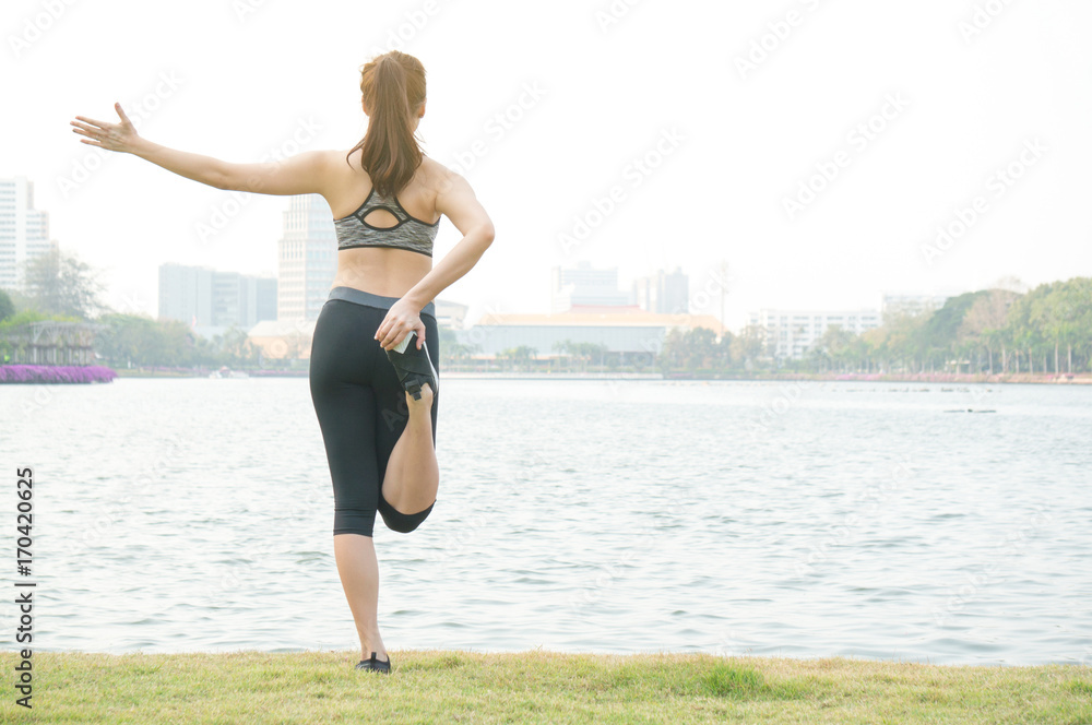 Asian sport woman feeling relax with yoga on lake in park Asian sport woman feeling relax with yoga on lake in park
